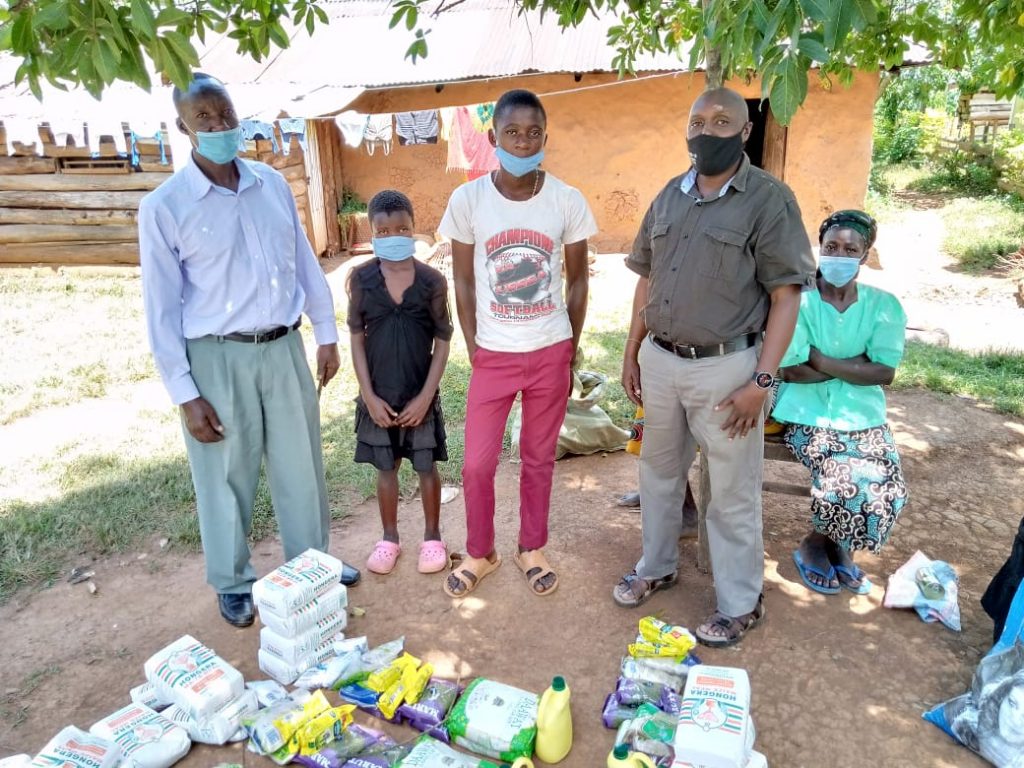 The jiggers team in Kenya standing by some of the food supplies for families