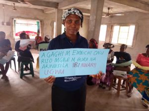 A person holding up a sign about ending FGM/C